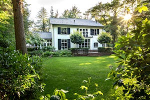 beautiful-white-house-with-a-green-garden-surround